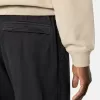 Losvallende joggingbroek met drukknopen en zakken met ritssluiting Losvallende joggingbroek met drukknopen en zakken met ritssluiting